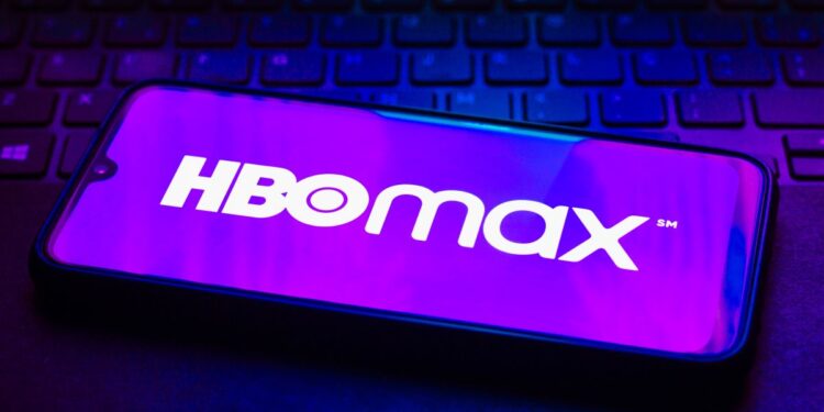 The HBO Max logo on a phone on top of a keyboard