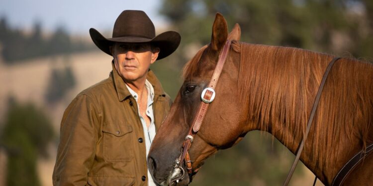 Kevin Costner as John Dutton, next to a horse, in Yellowstone