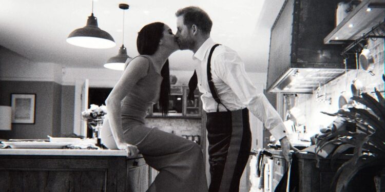 (L to R): Meghan Markle and Prince Harry kiss in the kitchen in an image from the Harry and Meghan docuseries