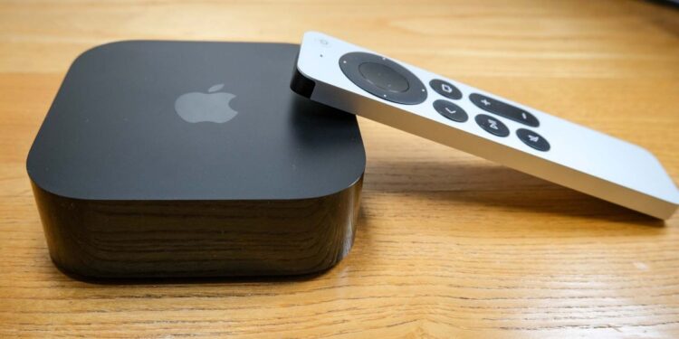 The Apple TV 4K (2022), with the Siri remote propped on its right side.